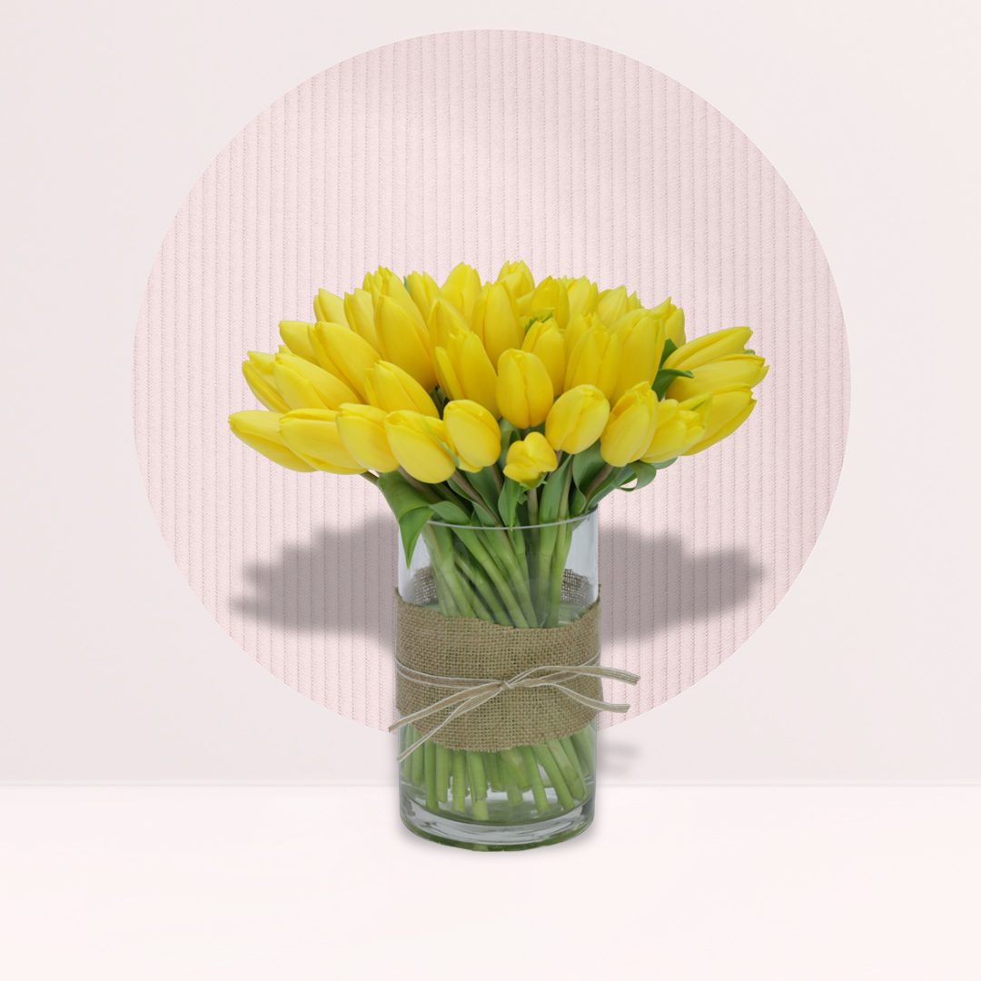 16 (4) Fresh yellow tulips arranged in an elegant decorative vase.
