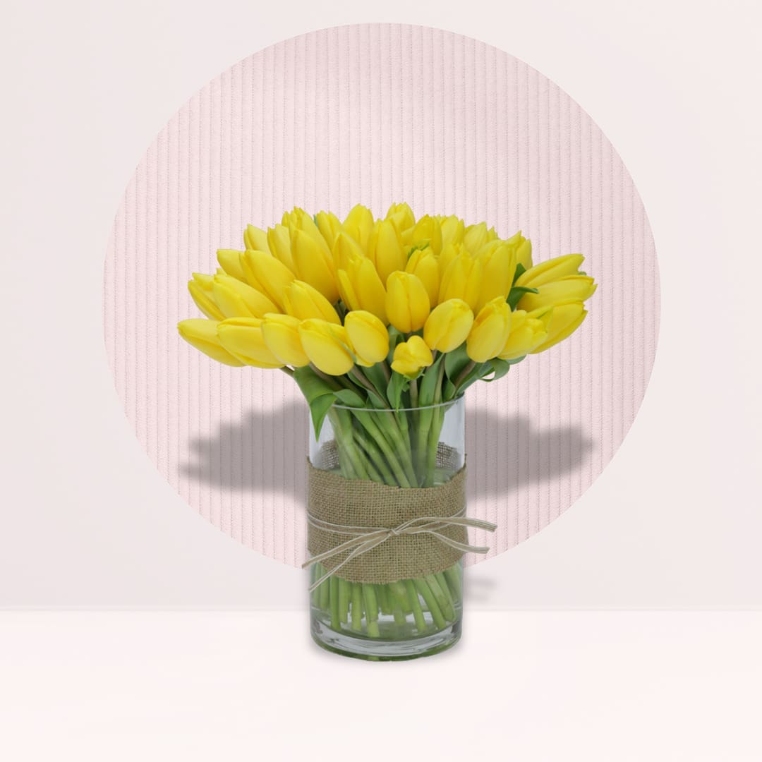 16 (4) Fresh yellow tulips arranged in an elegant decorative vase.