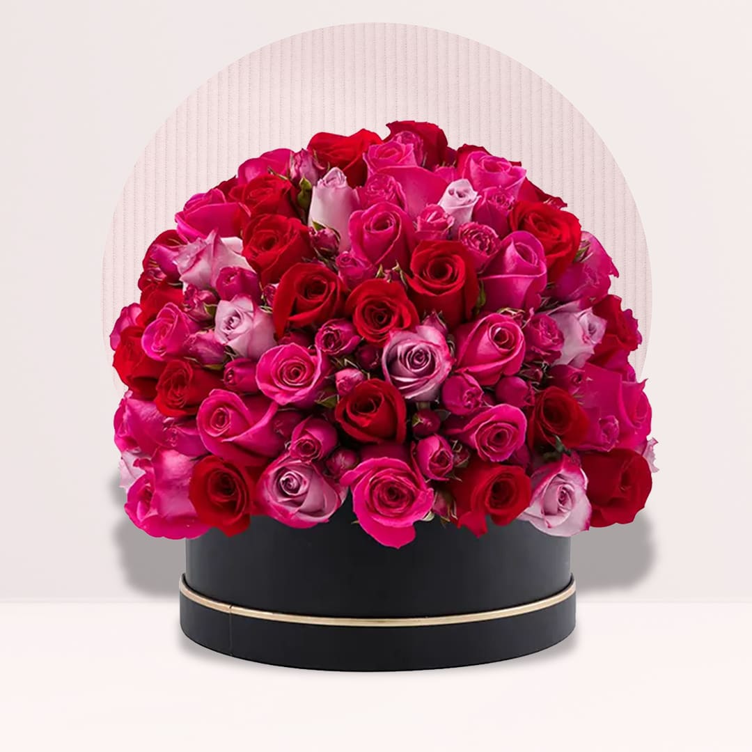 25 (4) Red pink and blush roses arranged in a black round hat box