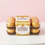 Ferrero Rocher hazelnut chocolates in a clear rectangular gift box.