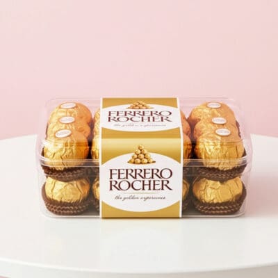 Ferrero Rocher hazelnut chocolates in a clear rectangular gift box.