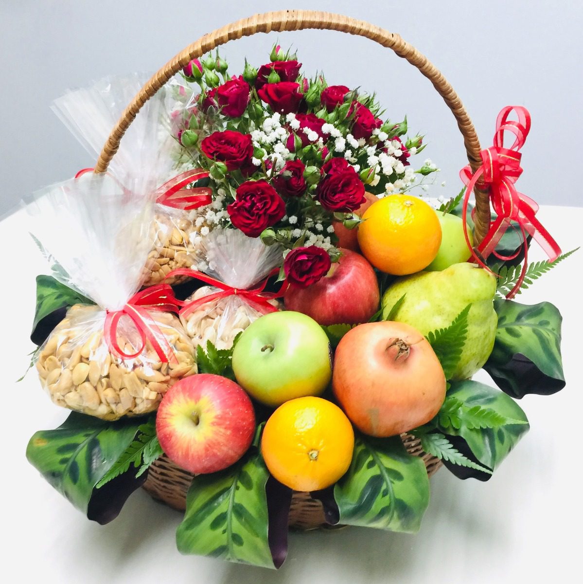 Fruits Hamper Fresh Harvest fruit hamper with mixed fruits, spray roses, peanuts and cashew nuts