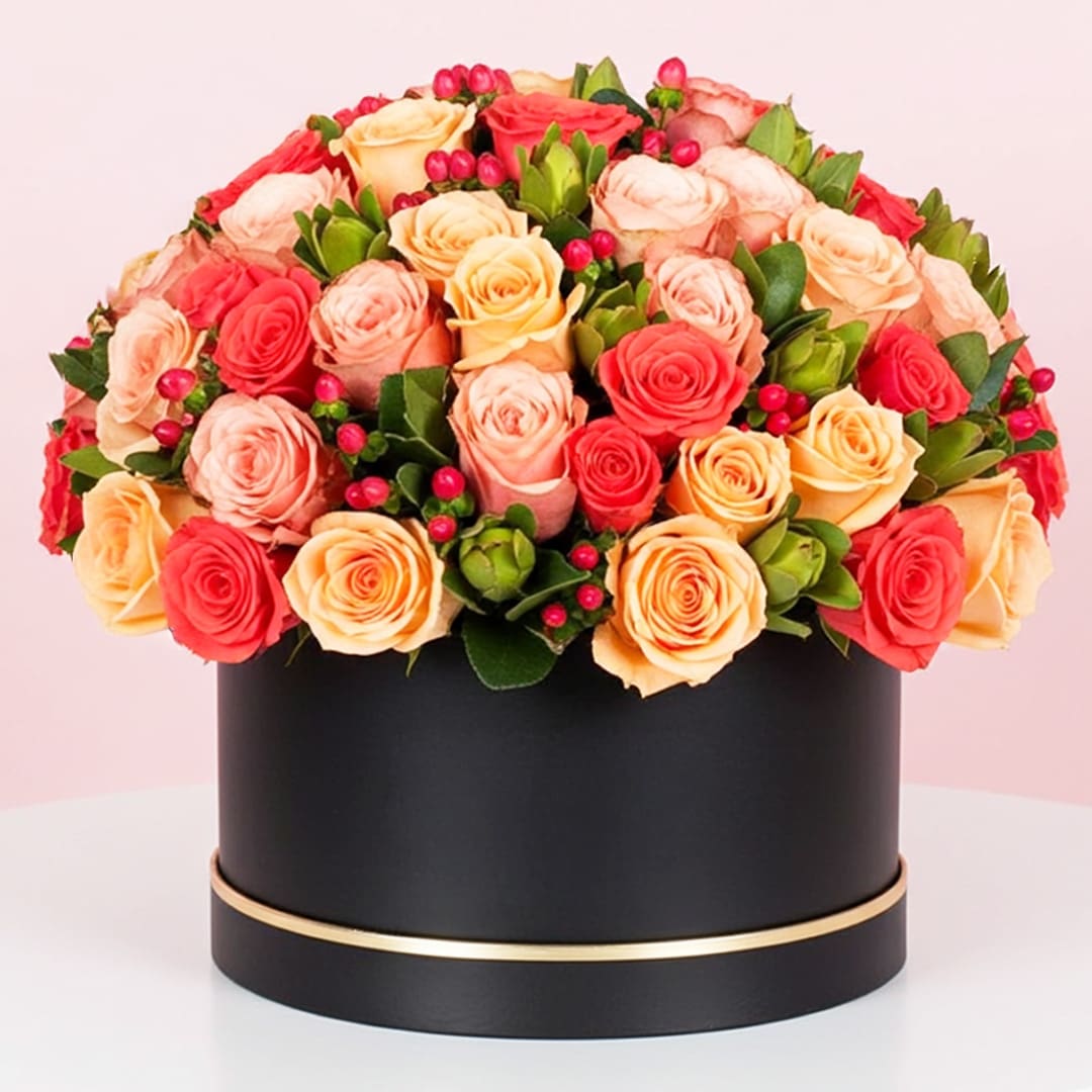 Signature Box of Mix Orange Roses-01-09-25 A large black box filled with vibrant orange and red roses, creating a striking floral display.