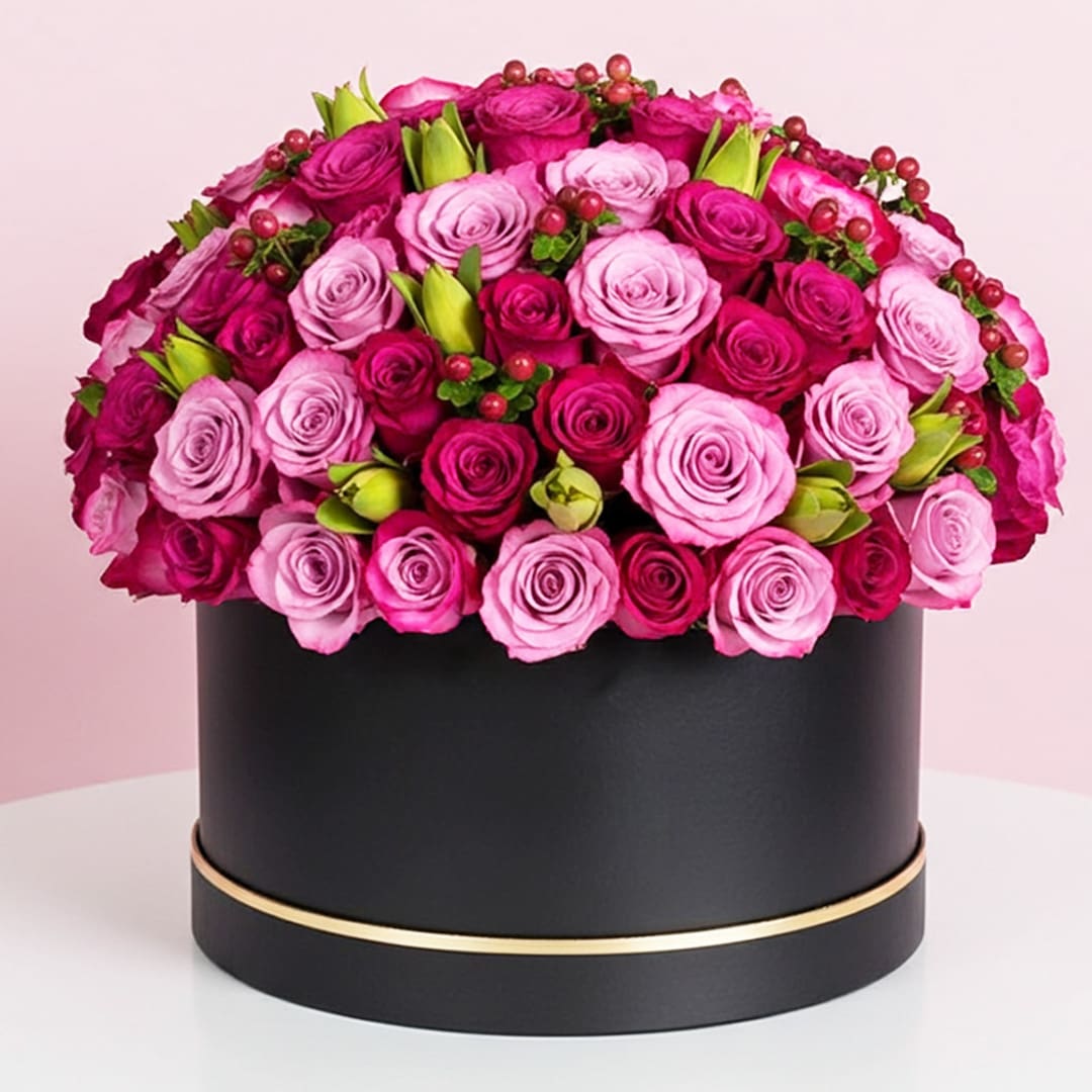 Signature Box of Purple Roses-29-09-25 A large black box adorned with vibrant pink and purple roses, creating a striking floral contrast.
