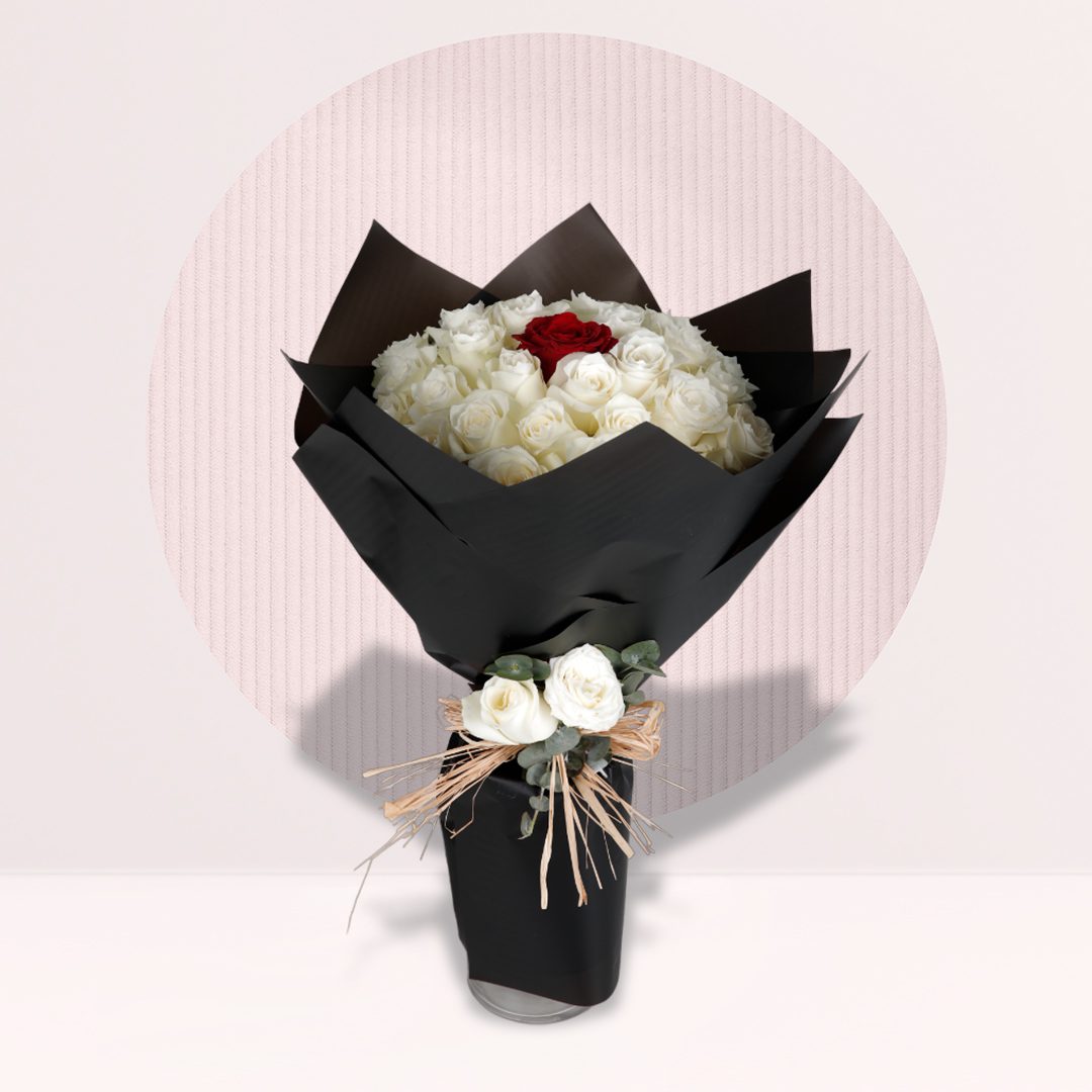 Rose Bouquet White rose bouquet with a single red rose accent in black wrapping