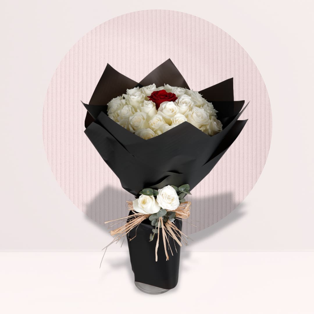 Rose Bouquet White rose bouquet with a single red rose accent in black wrapping