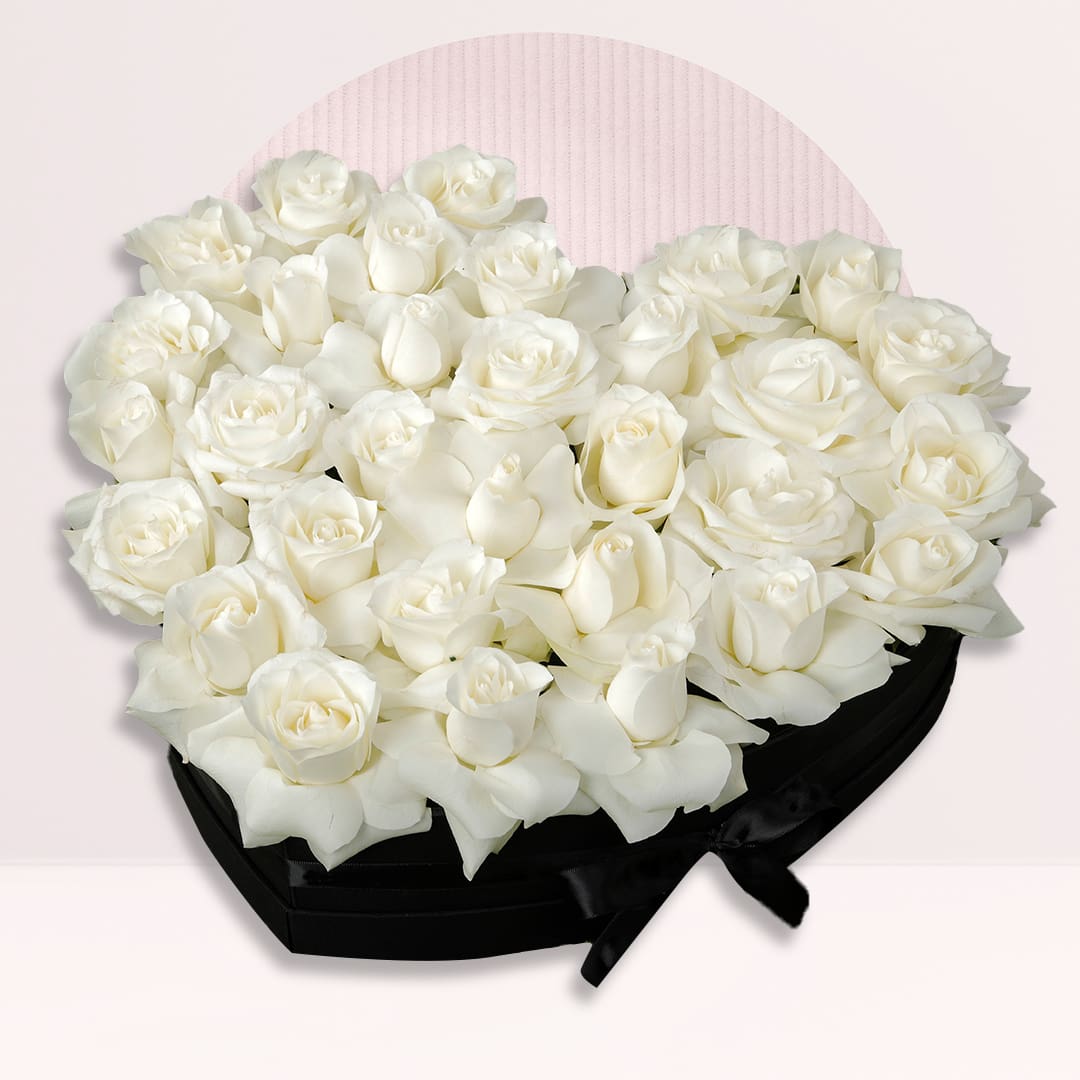 Heart Shap Rose Box White roses arranged in an elegant black heart-shaped flower box