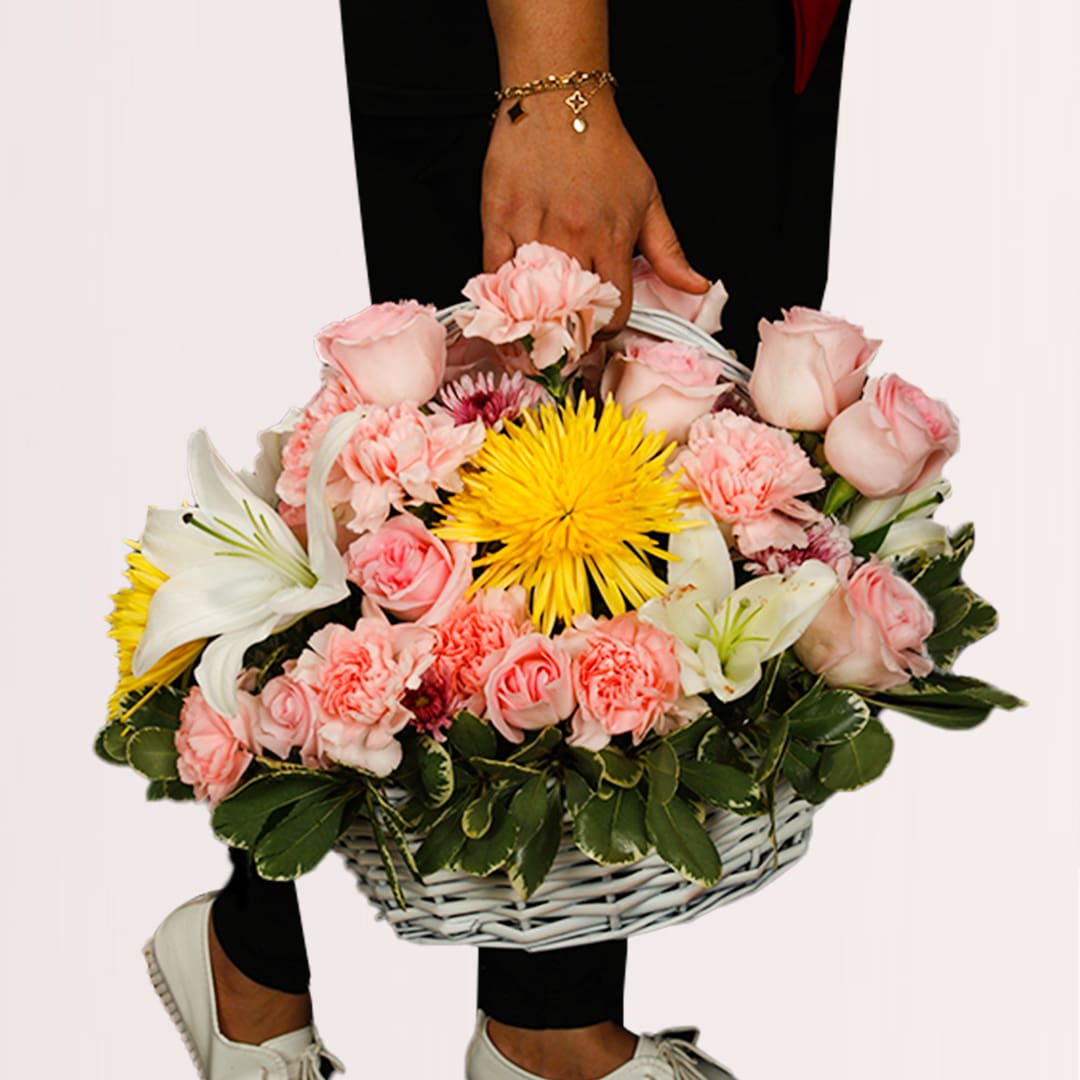 Basket Of Flower Pink rose, white lily, carnation and yellow chrysanthemum basket with seasonal greenery