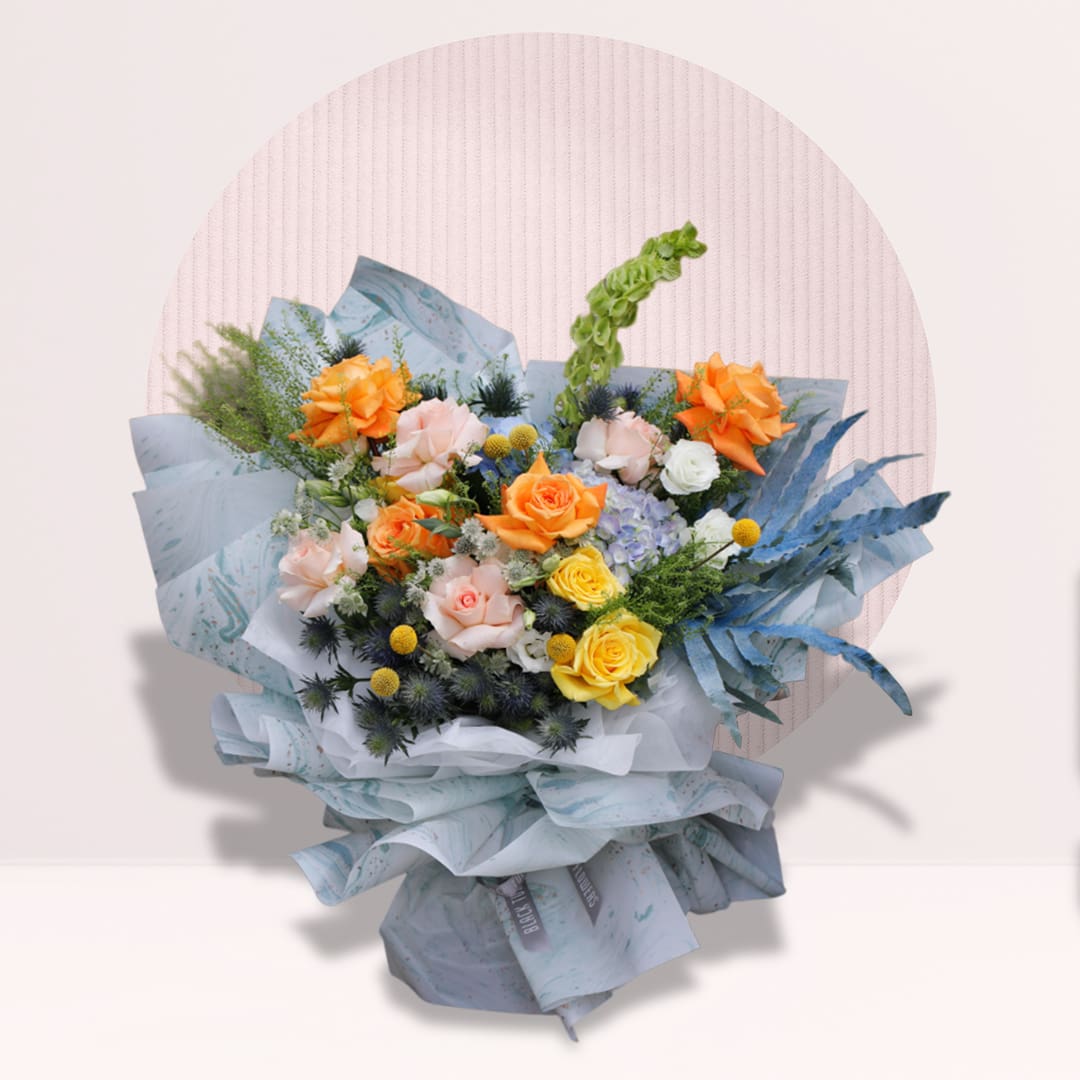 1 Pink and yellow rose bouquet with orange roses, mixed fillers and greenery.