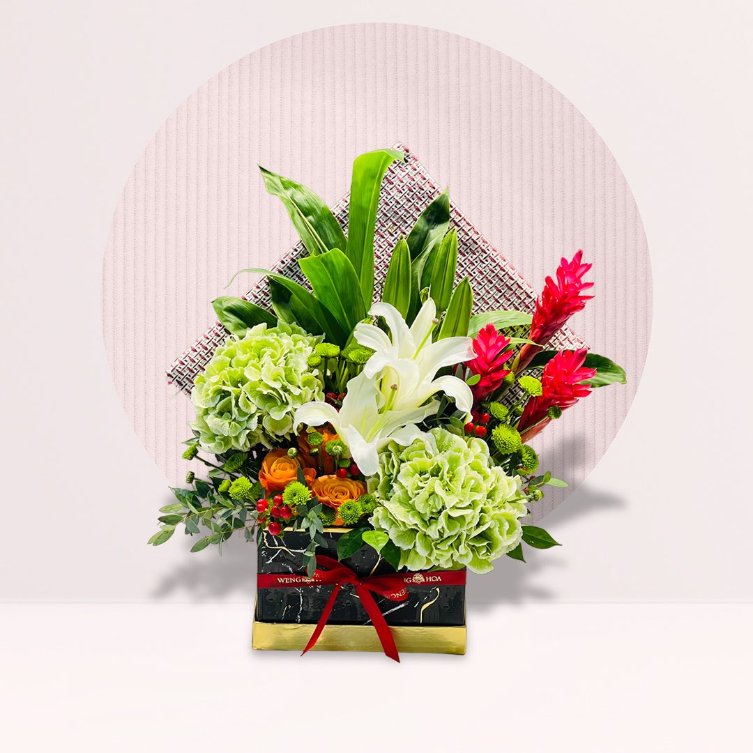 Box Of Flowers Green hydrangeas with white lilies orange roses and tropical blooms in flower box