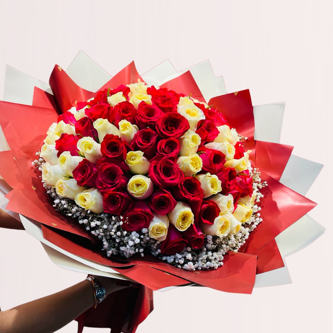 24 Grand Romance Rose Bouquet featuring 99 red and yellow roses accented with delicate baby’s breath in a luxurious hand-tied floral arrangement.