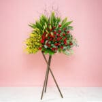 Grand Opening Stand Featuring 40 Red Roses, 25 Yellow Golden Showers, And Seasonal Greenery.