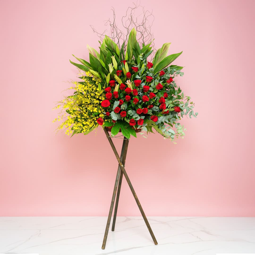 glory-25 Grand Opening Stand Featuring 40 Red Roses, 25 Yellow Golden Showers, And Seasonal Greenery.