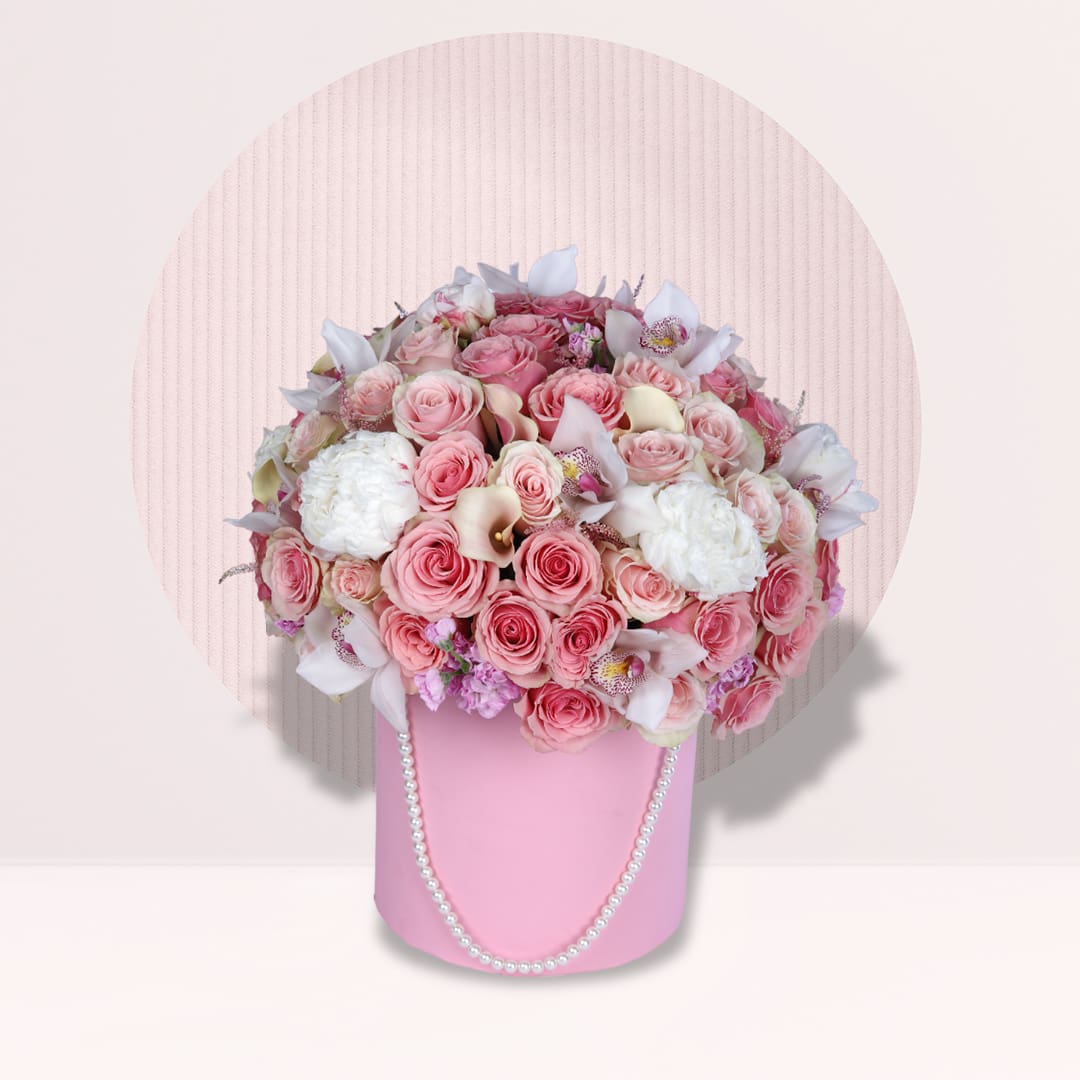 1 Blush pink roses and white orchids arranged in a pink luxury flower box