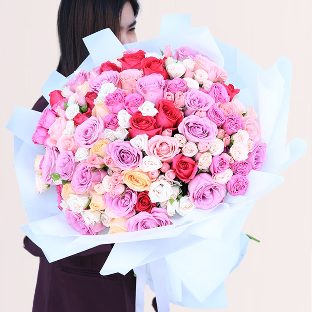13 Large mixed rose bouquet with purple, dark pink, light pink, peach and white roses in elegant wrapping