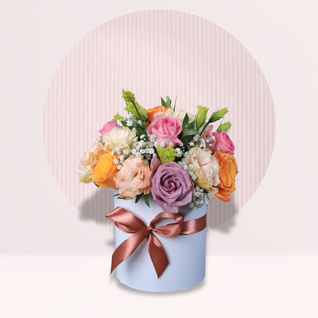 21 Pastel pink peach orange and mauve roses in round flower box