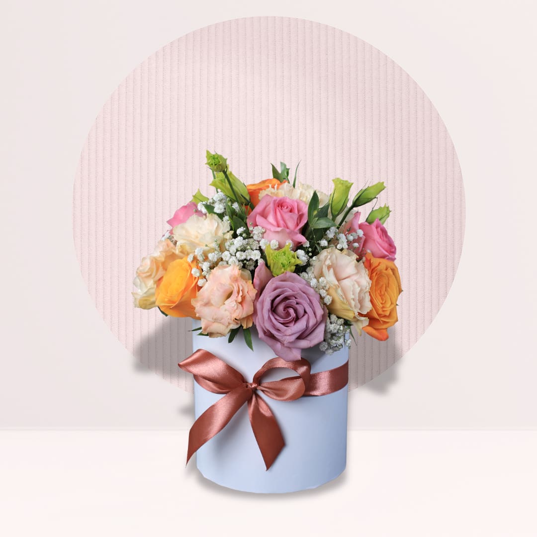 21 Pastel pink peach orange and mauve roses in round flower box