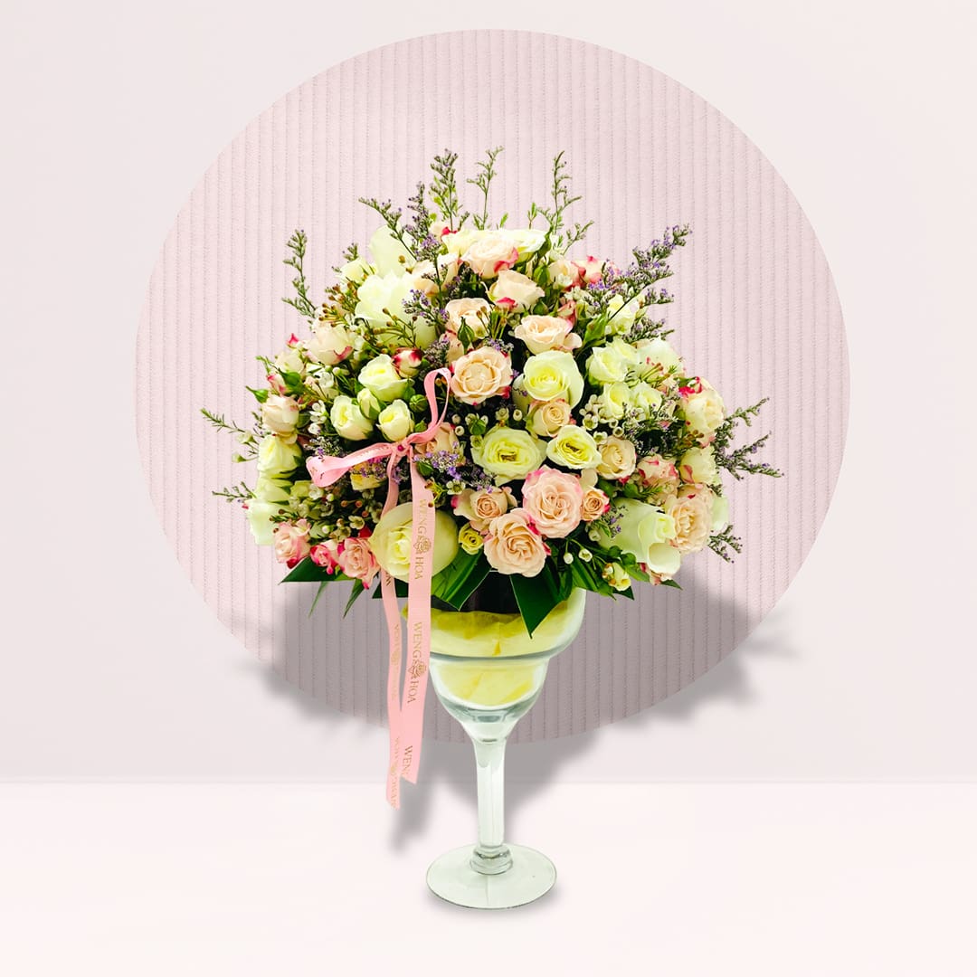 4 Glass vase arrangement with pink and white roses, pastel flowers and delicate fillers.