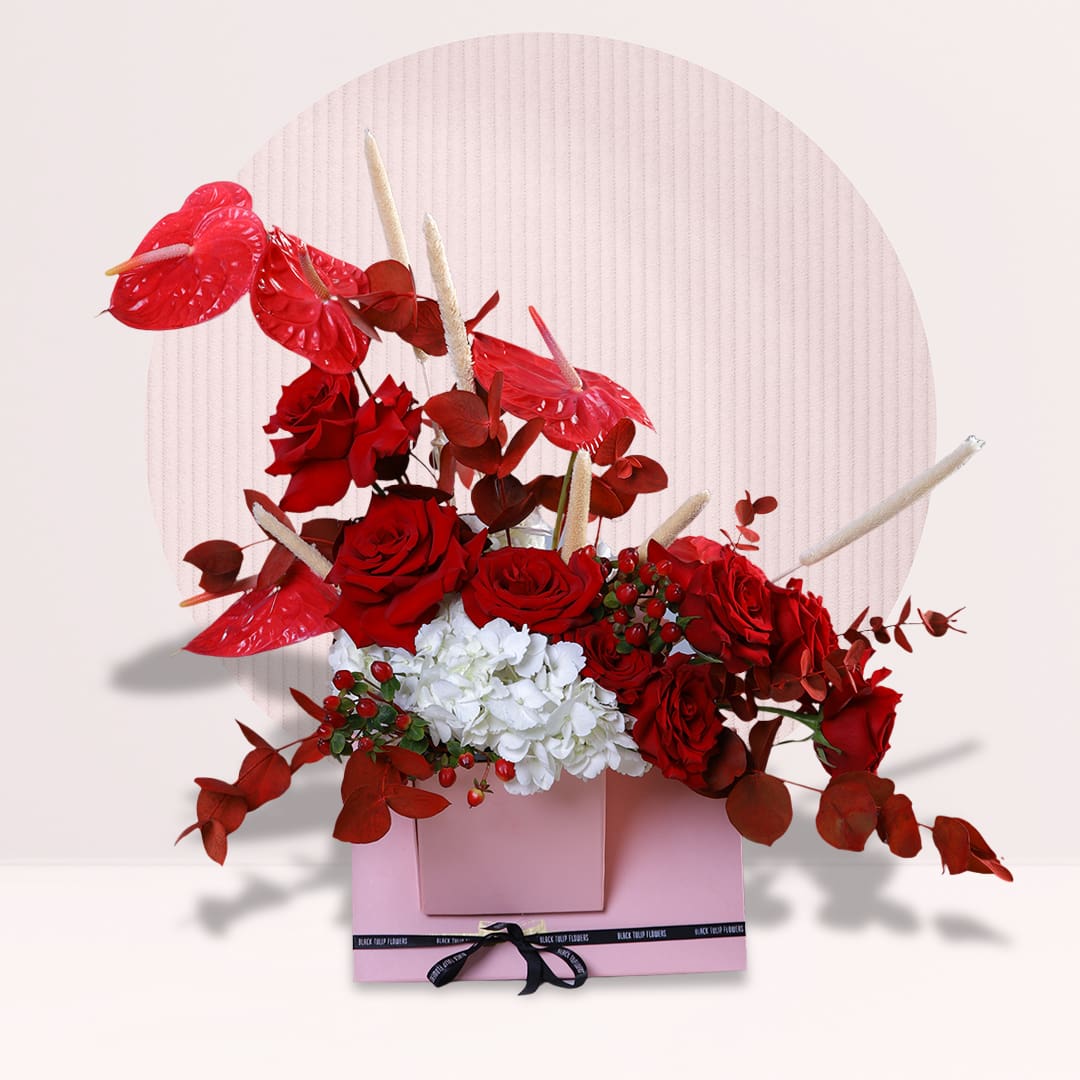 1 Red roses and anthuriums with white hydrangea in pink flower box