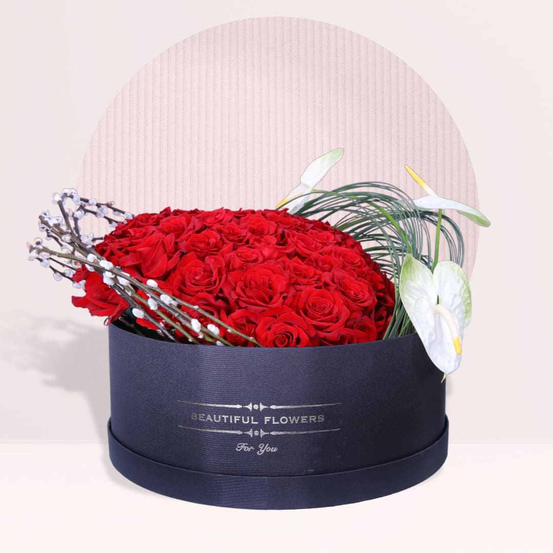 1 80 red roses with white anthuriums and steel grass in black flower box