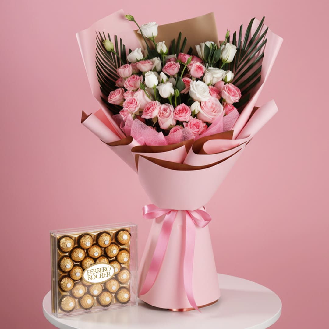 Romantic Rosecade-01 A bouquet of pink roses alongside a box of chocolates on a pink table