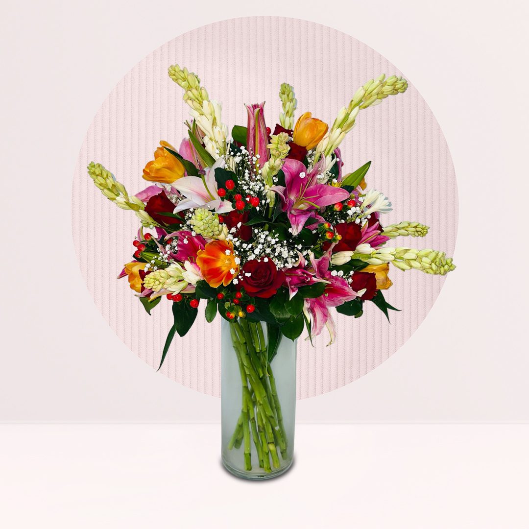 1 (38) Fresh tulips and complementary flowers arranged in a decorative vase.