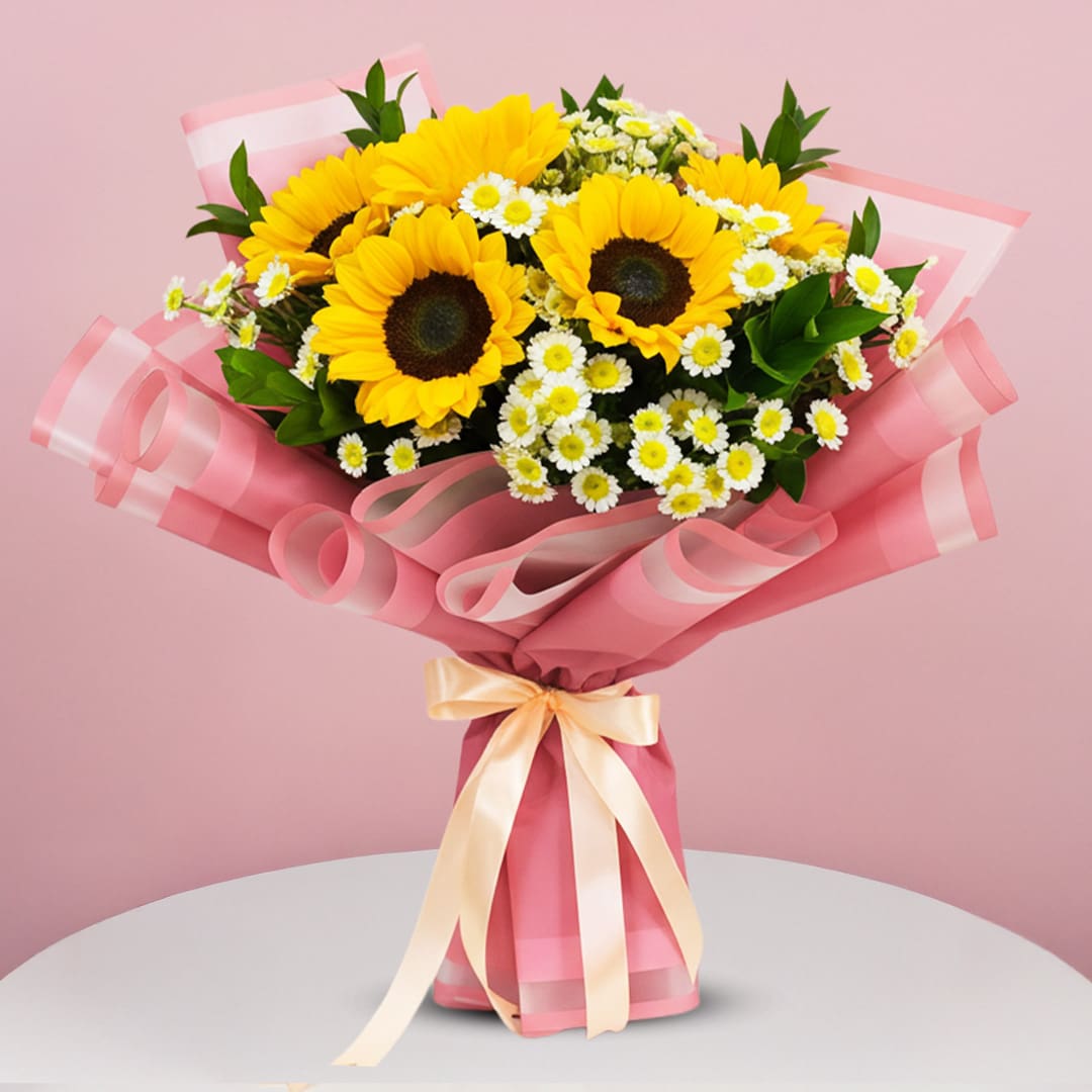 Pink Springtime Bouquet-01-25 A bouquet featuring sunflowers and daisies in a white table