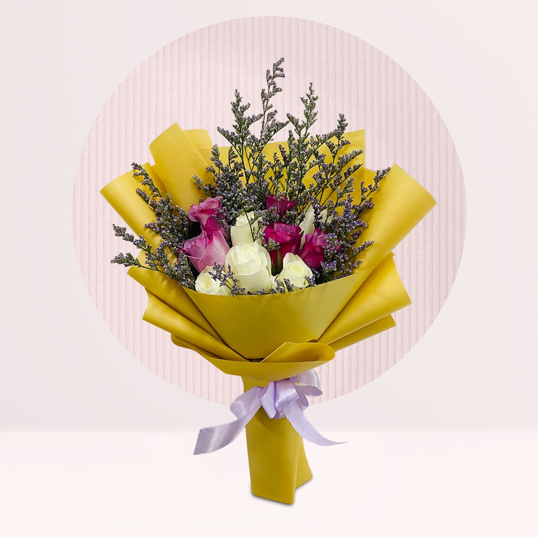 1 (214) Purple and white rose bouquet with purple fillers, greenery and bright yellow wrapping