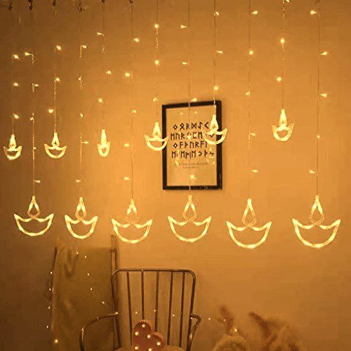 Diwali LED String Lights: A string of LED lights shaped like diyas, hanging on a wall. The warm, golden light creates a festive and inviting atmosphere.