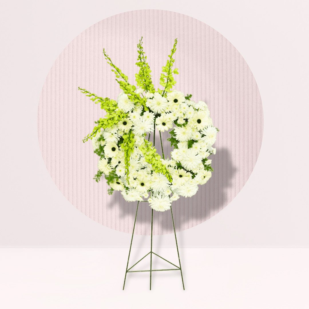 Floral Wreath: The central element is a circular wreath made of white flowers, possibly chrysanthemums or daisies. The wreath has a dense, full appearance.