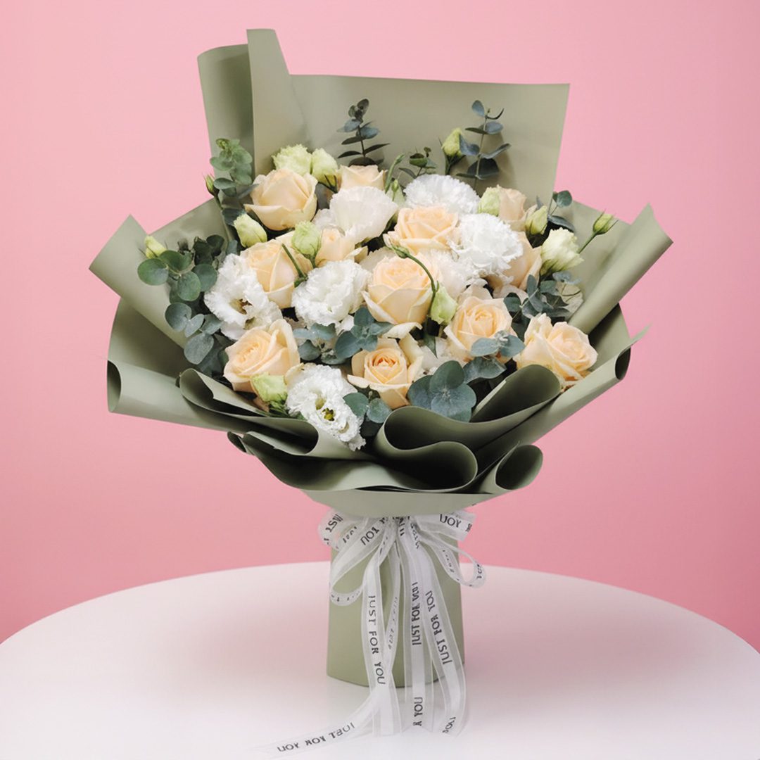 01 Bouquet of peach roses and white eustoma with eucalyptus wrapped in olive green paper.
