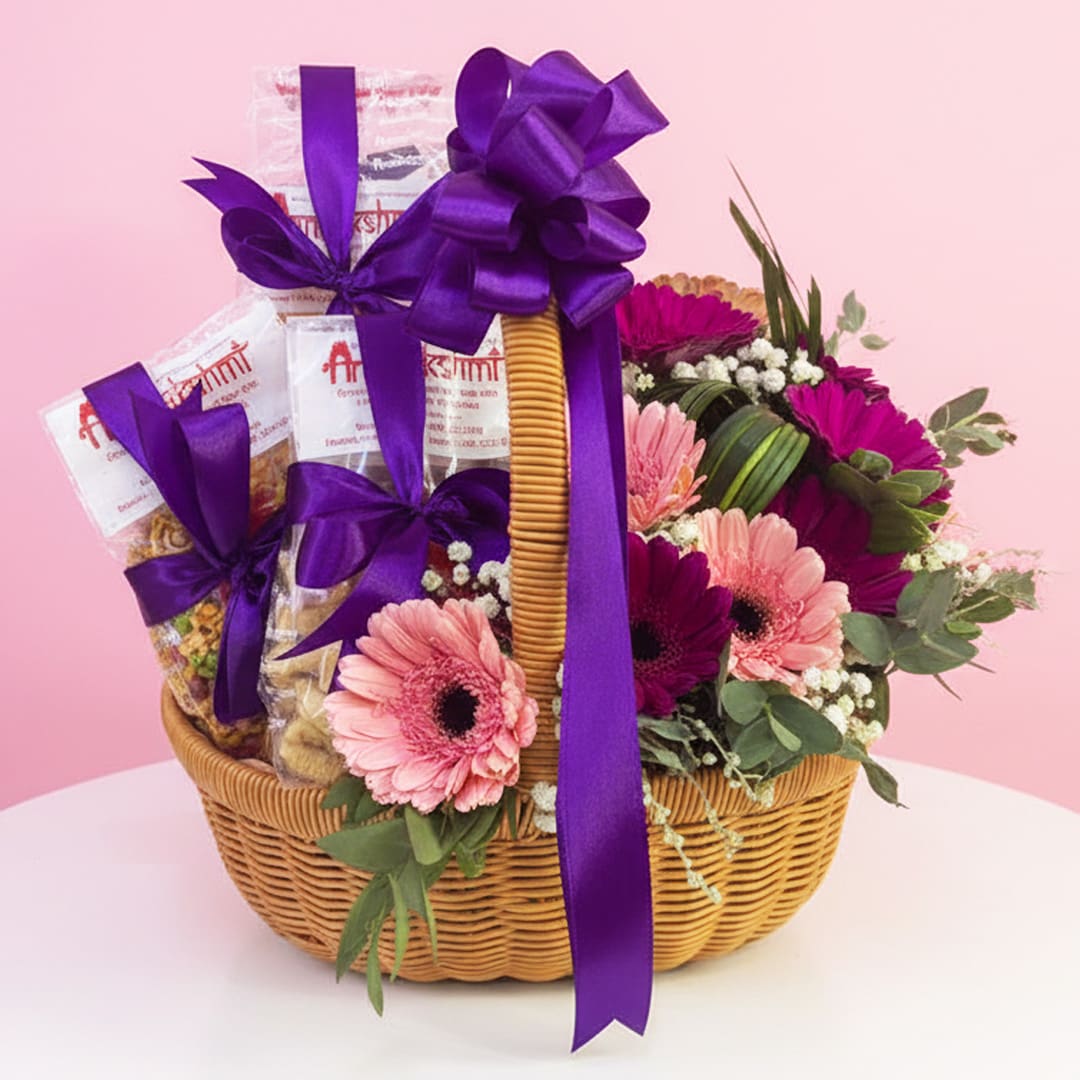 01 Treat and flower basket with pink and purple gerberas, white fillers, and purple ribbon decorations.