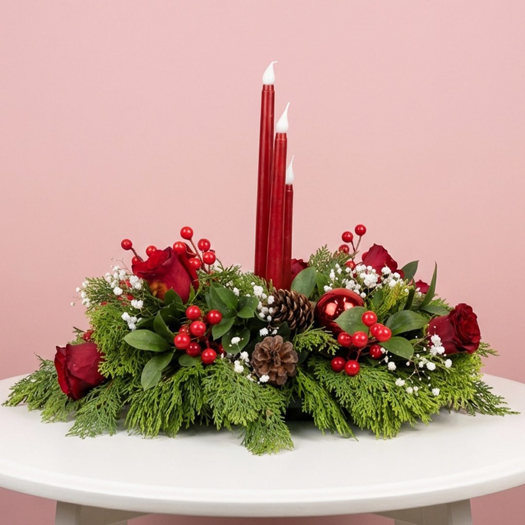01 Red led candle Christmas centerpiece with red roses, berries, pine cones and festive greenery.