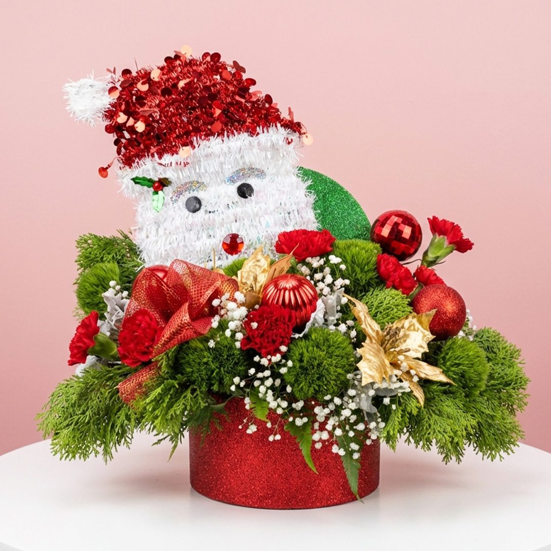 01 Santa themed Christmas arrangement featuring vibrant red flowers, gold poinsettias, lush greens, and Christmas ornaments—perfect for brightening homes, parties, and holiday celebrations.