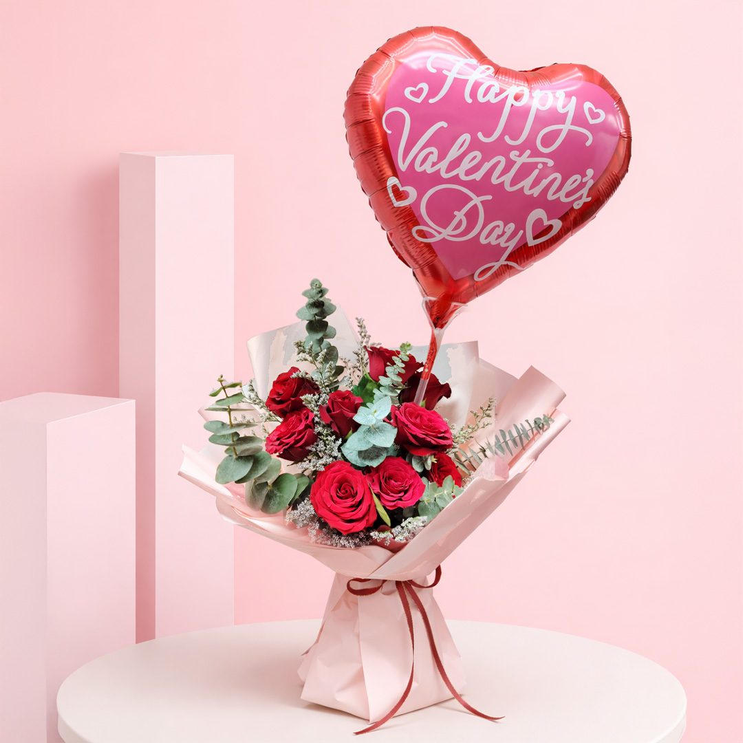 01 Red roses bouquet with heart balloon and green foliage wrapped in pink paper and a Happy Valentine’s Day heart-shaped balloon