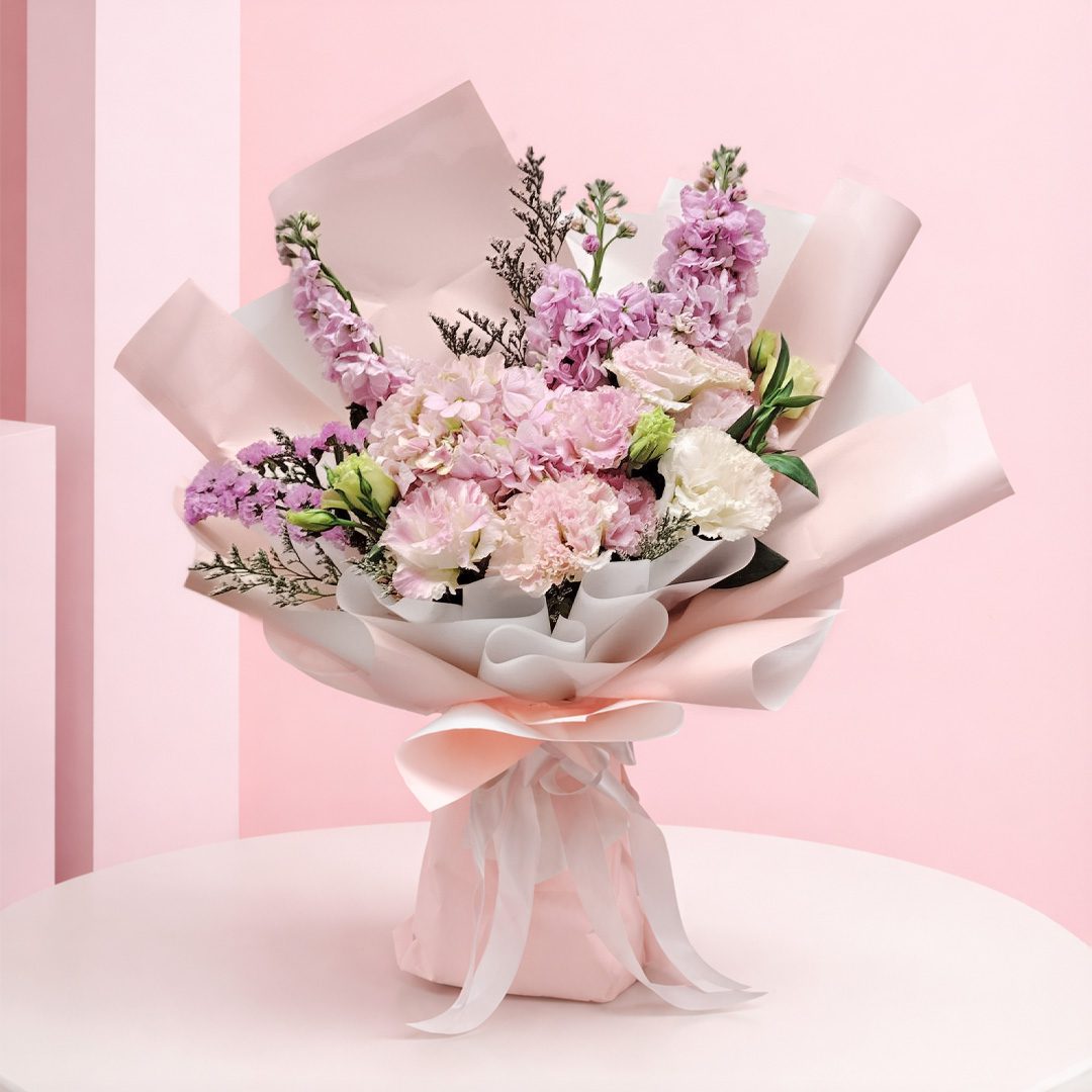 01 featuring pink hydrangea bouquet seasonal pink flowers and delicate fillers in blush wrapping, finished with a soft ribbon bow.
