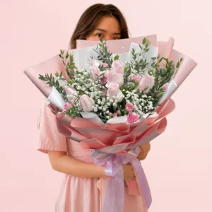 Blush pink rose and carnation bouquet with baby’s breath and greenery