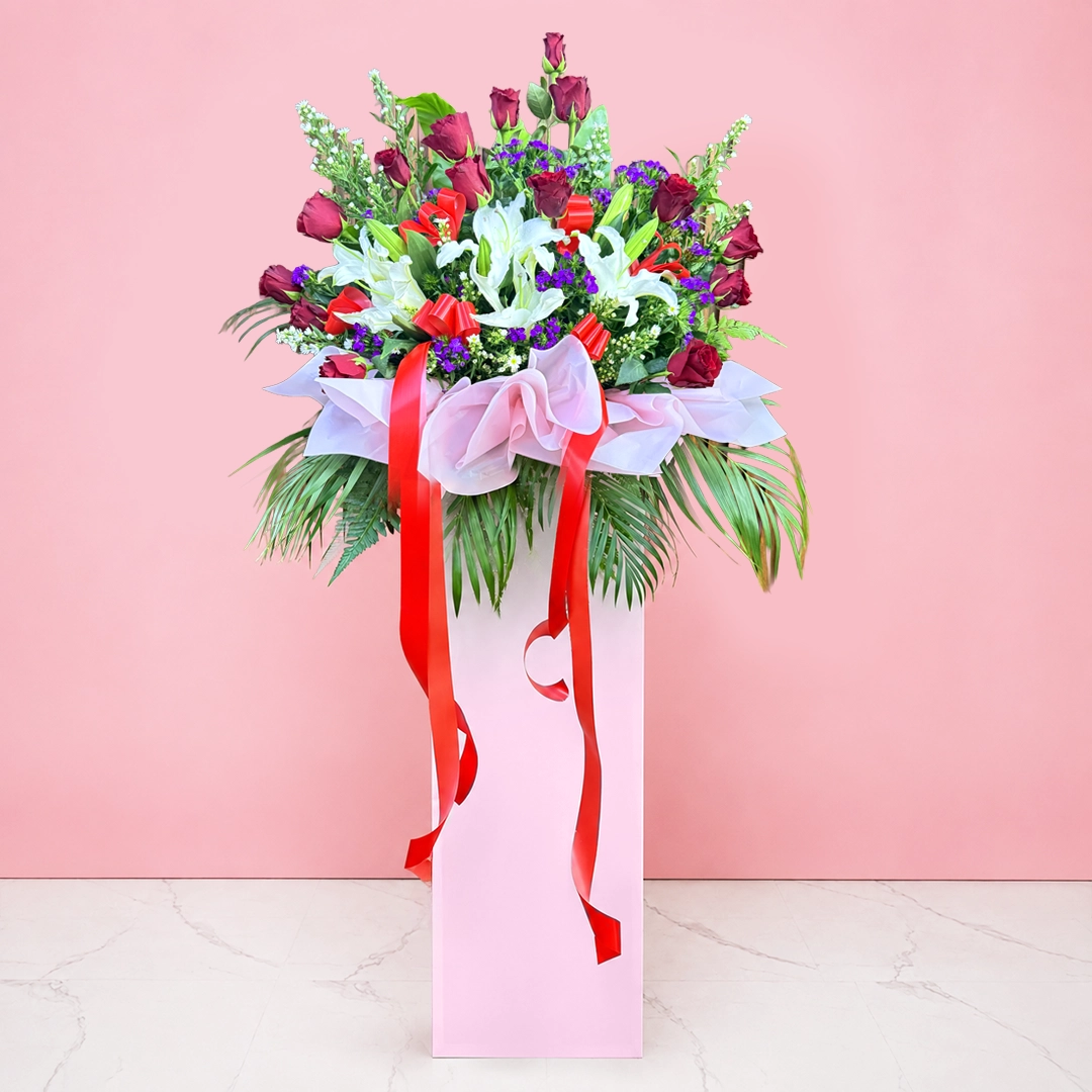 grand-opening-elegance-stand Grand Opening flower stand with red roses, white lilies, purple fillers and red ribbons.