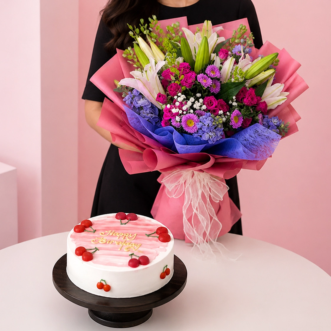 lily-bouquet-black-forest-combo Orchid Bouquet Mixed Fruit Cake Combo featuring a 15-stem purple orchid bouquet paired with a vanilla chiffon mixed fruit cake layered with custard cream and mixed fruit cubes.