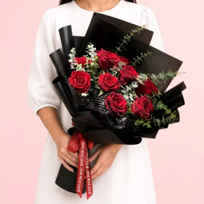 Luxury Red Rose Bouquet featuring vibrant red roses arranged with textured greenery and wrapped in a sleek contemporary style for elegant gifting and special occasions.