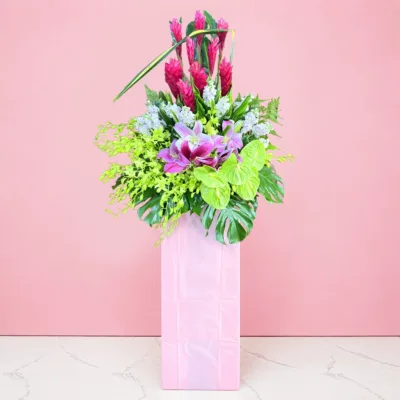 Grand Opening flower stand with pink lilies, red ginger flowers, anthurium and tropical foliage