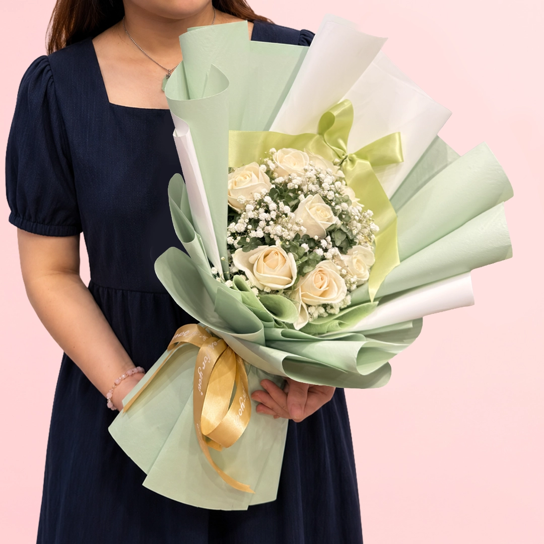 signature-rose-bouquet White rose and baby’s breath bouquet in elegant sage green wrapping