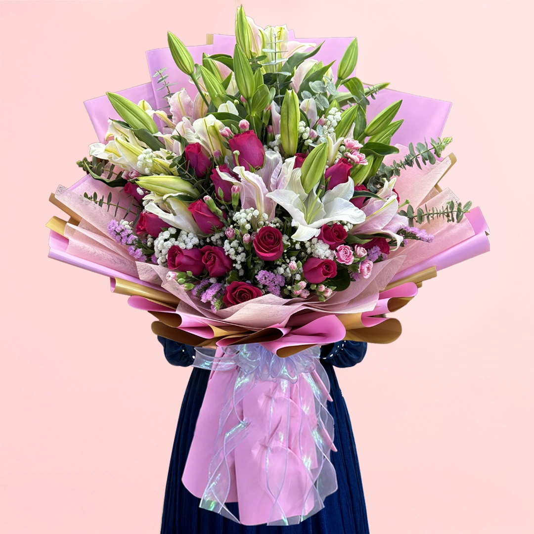 signature-lily-rose-bouquet Signature Lily & Rose Bouquet featuring fresh lilies, roses, statice, spray carnations, baby’s breath, and eucalyptus arranged in an elegant floral design.