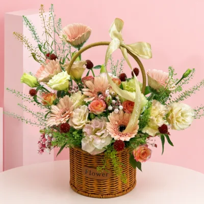 6 peach gerberas, delicate spray rose, lisianthus bloom, gomphrena flowers, seasonal fillers, and foliage arranged in a premium woven basket.