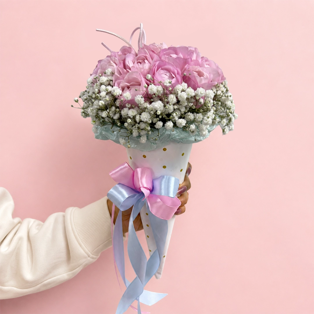 blush-spray-rose-cone Cone-style hand bouquet with Pink spray roses, baby’s breath tied with a decorative ribbon