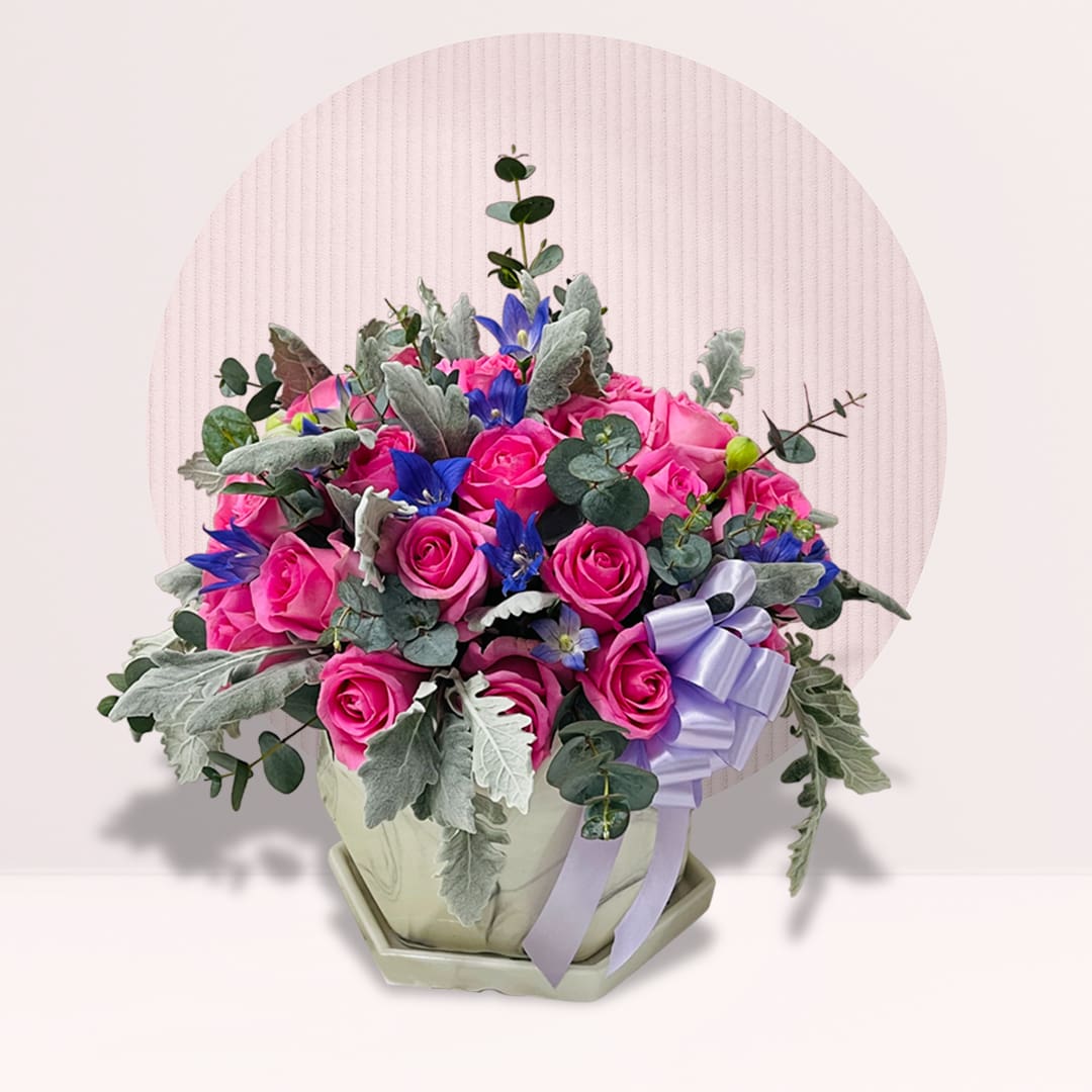 19 Stylish vase arrangement with vibrant hot pink roses.