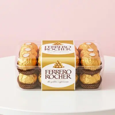 Ferrero Rocher hazelnut chocolates in a clear rectangular gift box.