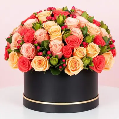 A large black box filled with vibrant orange and red roses, creating a striking floral display.