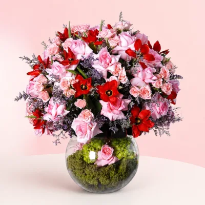 : Round vase of roses, spray roses, tulips and hydrangeas.