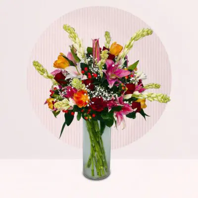 Fresh tulips and complementary flowers arranged in a decorative vase.
